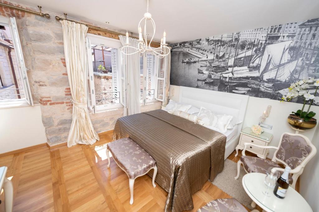 a bedroom with a bed and a table and chairs at Gothic Palace Heritage in Split