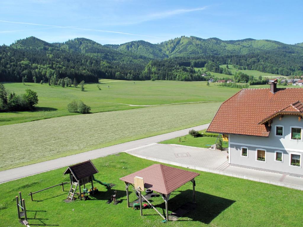 an overhead view of a house with a field and mountains at Apartment Ferienwohnung Lärche by Interhome in Oberwang
