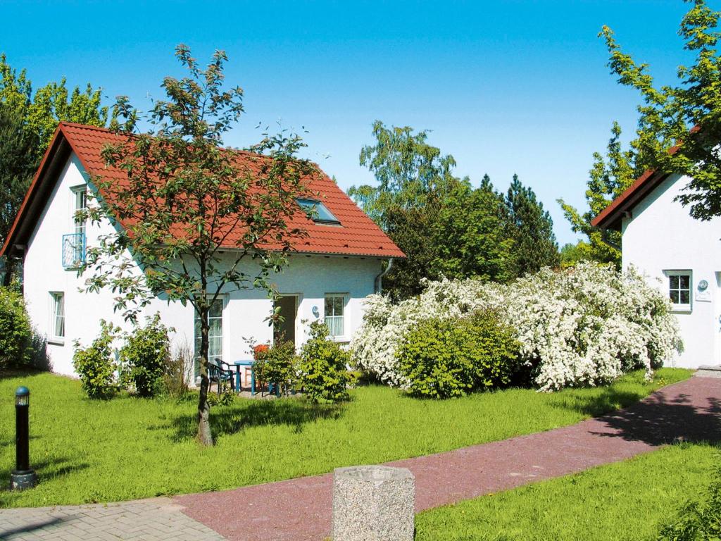 a white house with an orange roof at Holiday Home Lenzer Höh-1 by Interhome in Lenz