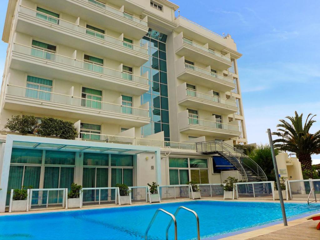 a hotel with a swimming pool in front of a building at Apartment Stella Marina by Interhome in San Salvo