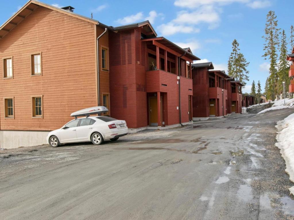 a white car parked in front of a building at Holiday Home Ruka sunhill by Interhome in Ruka
