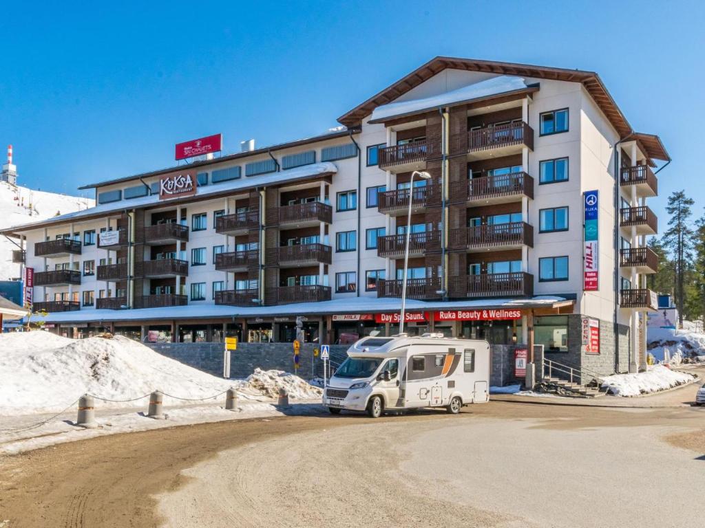 a white van parked in front of a building at Holiday Home Ruka ski chalets 64- 1503 by Interhome in Ruka