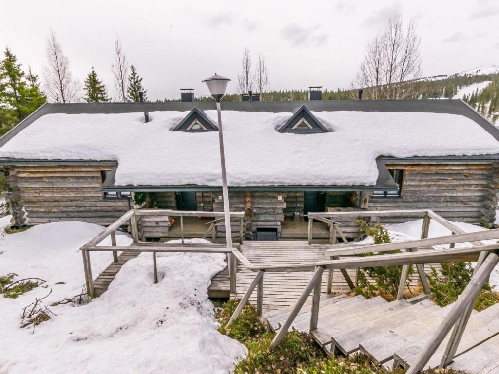 a log cabin with snow on the roof at Holiday Home Saaruanaho h1 by Interhome in Ruka