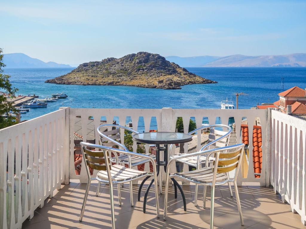 a table and chairs on a balcony overlooking the ocean at Holiday Home Stanka - SNJ218 by Interhome in Sveti Juraj