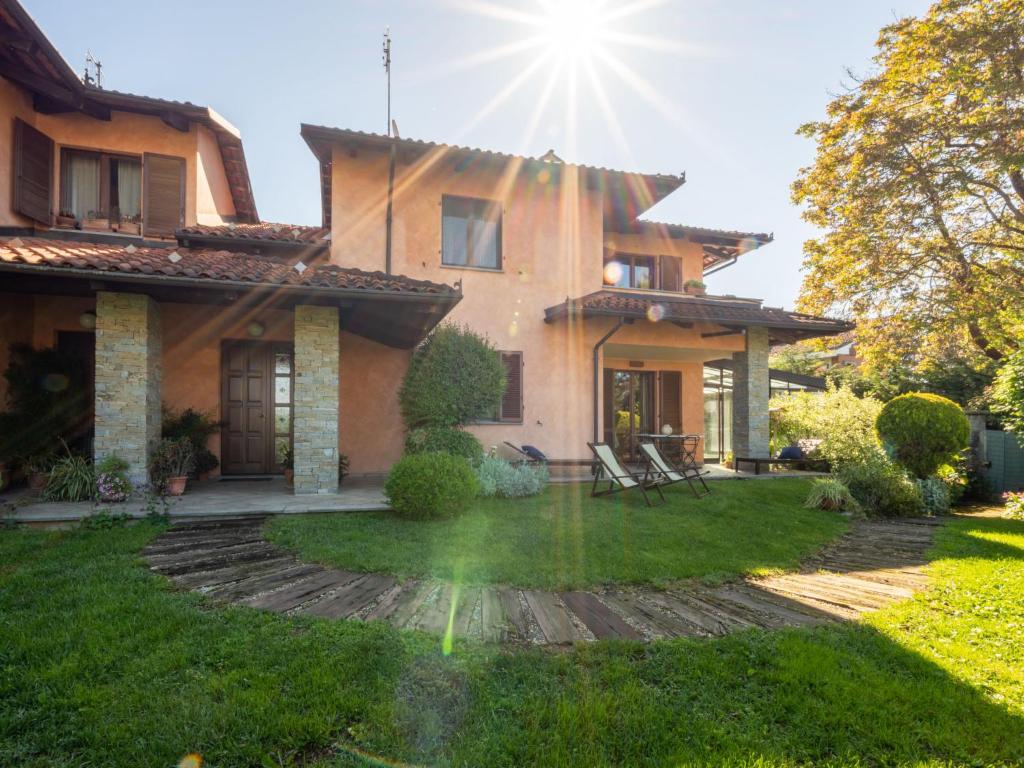 a house with the sun shining on the yard at Holiday Home I Briganti by Interhome in Narzole