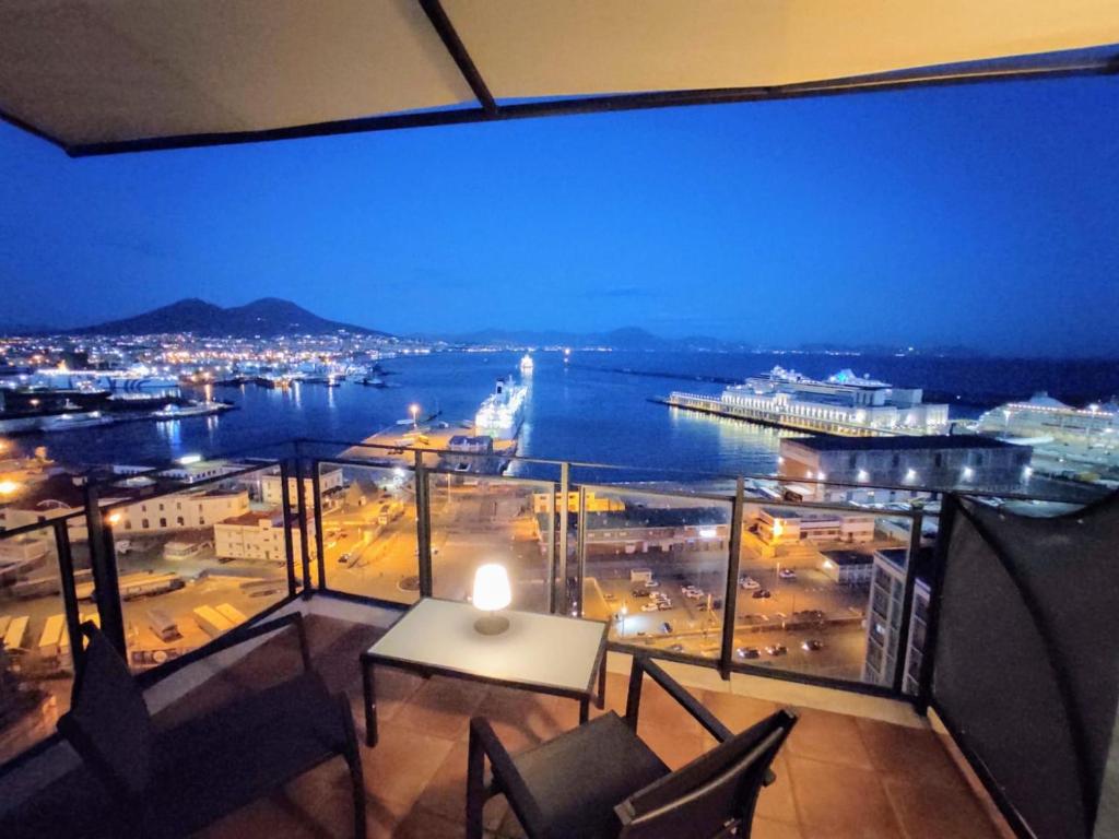 a balcony with a view of a city at night at My View Guest House in Naples