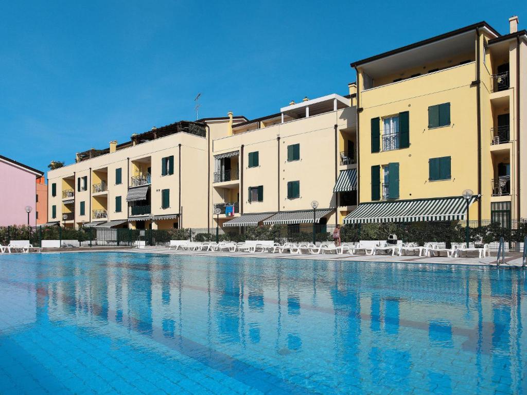 a large swimming pool in front of some buildings at Apartment Albatros-1 by Interhome in Caorle