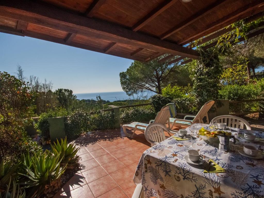 a patio with a table and chairs on a patio at Holiday Home Piccola Oasi 4 by Interhome in Capoliveri
