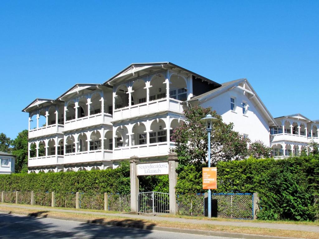 a large white building on the side of a street at Apartment Juliusruh-5 by Interhome in Juliusruh