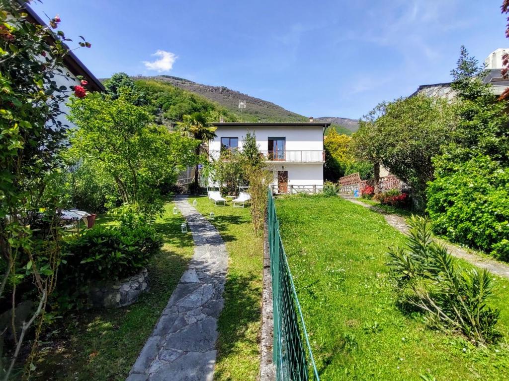 a garden with a fence in front of a house at Apartment Marta by Interhome in Gera Lario