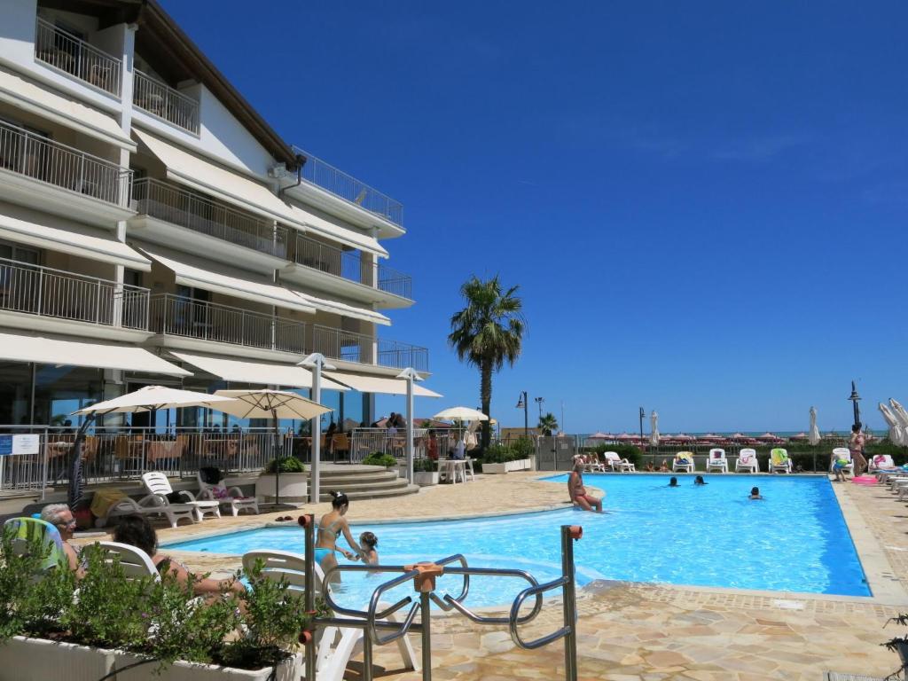 a pool at a hotel with people playing in it at Apartment Casa del Mar-1 by Interhome in Roseto degli Abruzzi