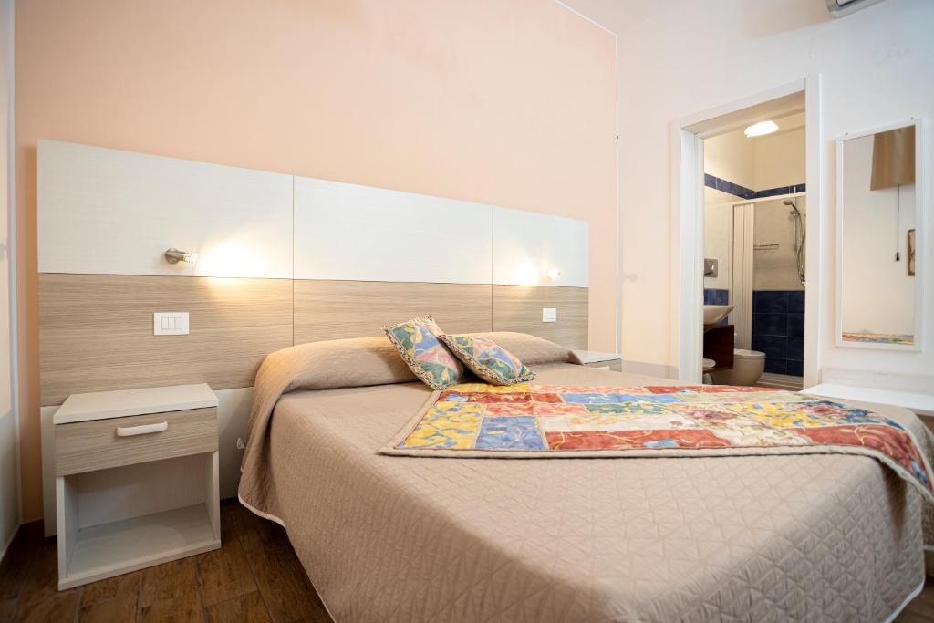 a bedroom with a bed with a large headboard at Trapani Home in Trapani