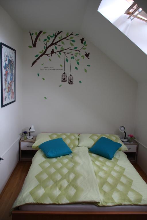 a bedroom with a bed with a tree on the wall at 238 Spodnje Gorje in Spodnje Gorje