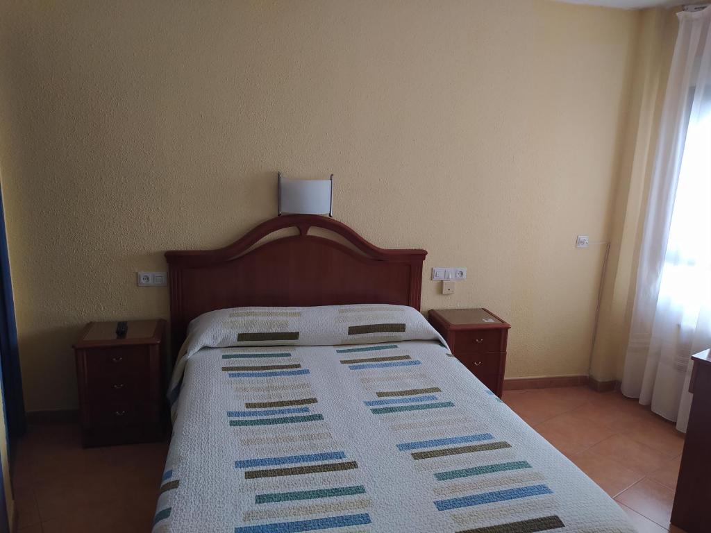 A bed or beds in a room at Hostal Guzman El Bueno by gaiarooms