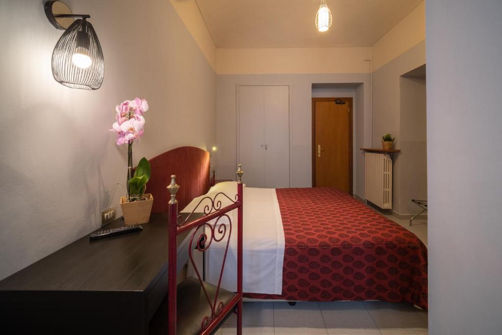 En eller flere senge i et værelse på Hotel Italia