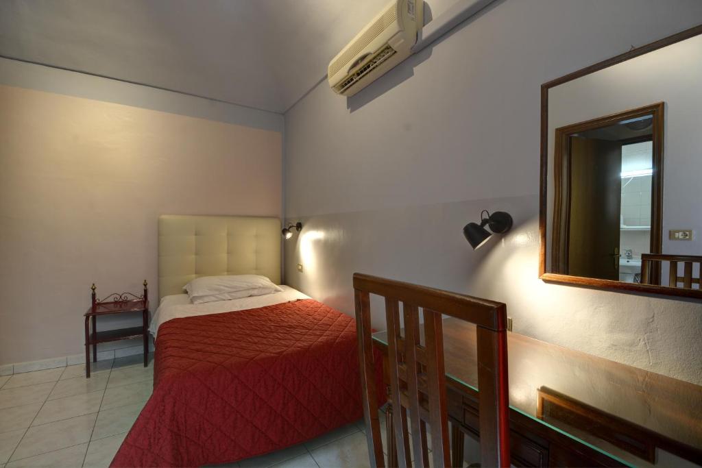 En eller flere senge i et værelse på Hotel Italia