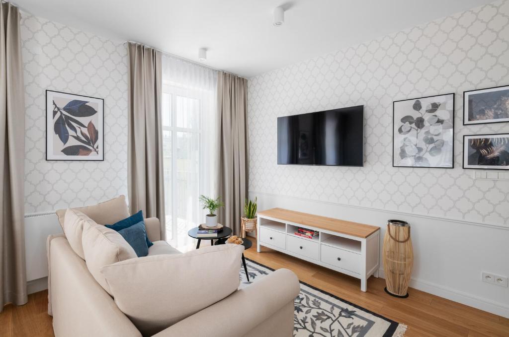 Televízia a/alebo spoločenská miestnosť v ubytovaní W Sercu Warszawy Apartamenty