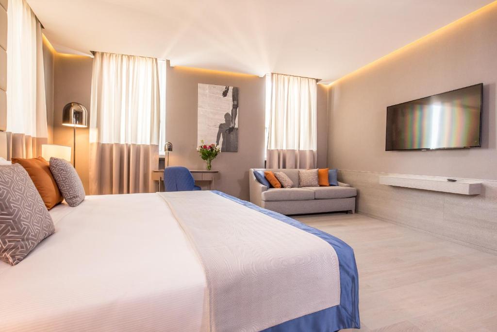 Postel nebo postele na pokoji v ubytování Orazio Palace Hotel