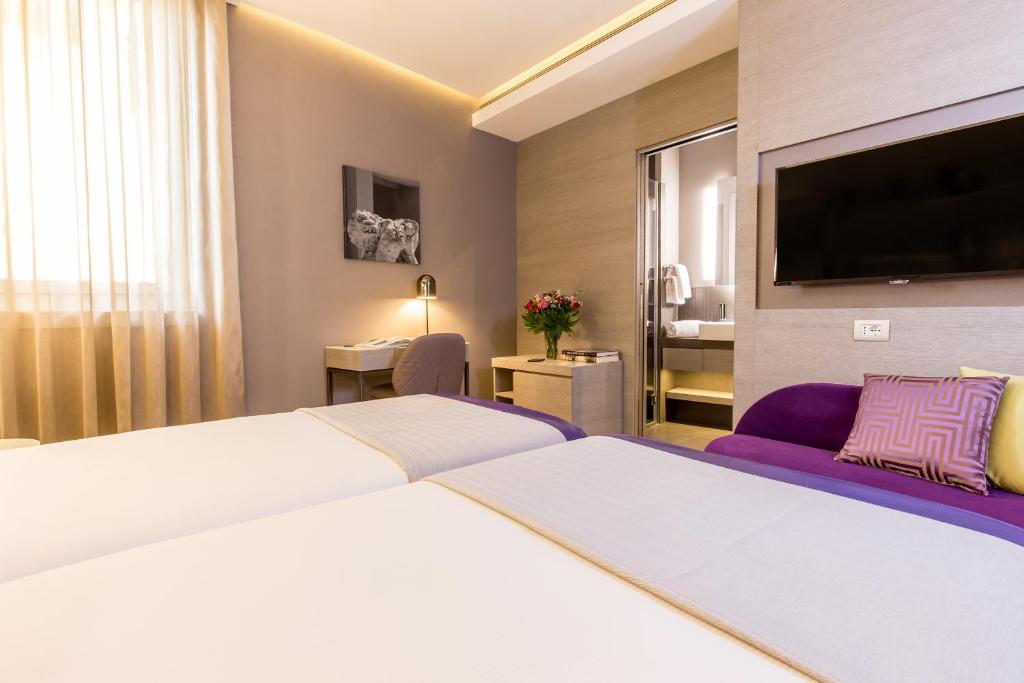 Postel nebo postele na pokoji v ubytování Orazio Palace Hotel