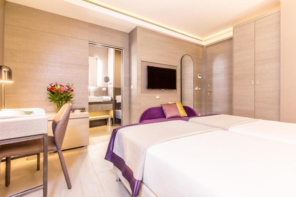 Postel nebo postele na pokoji v ubytování Orazio Palace Hotel