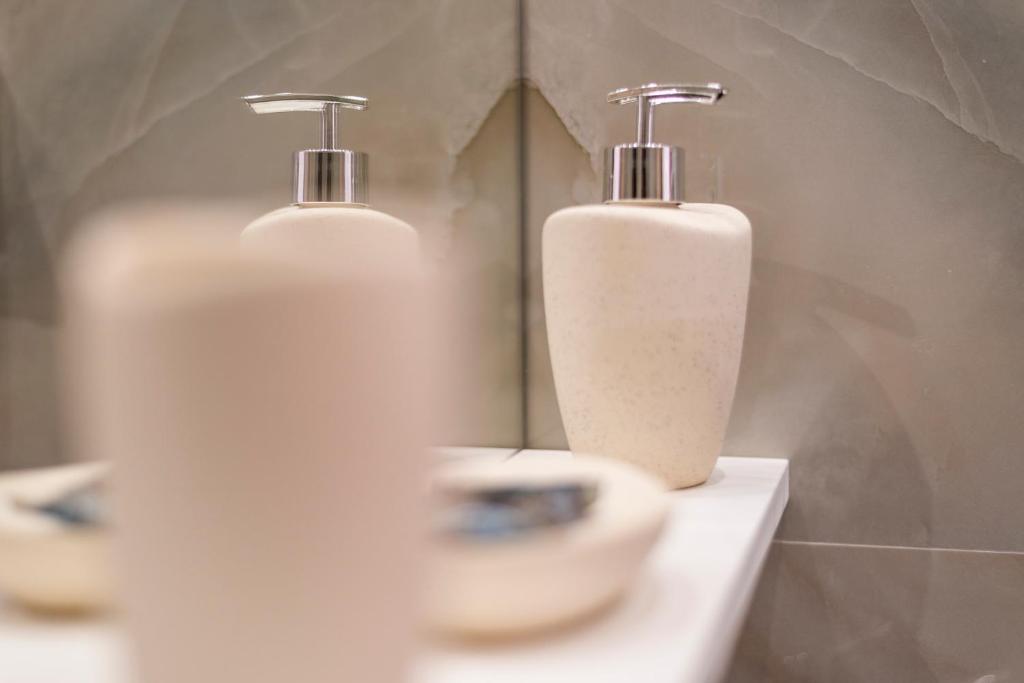 a bathroom with two soap bottles on a sink at sofia's cozy rooms in Himare