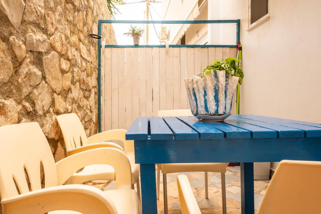 a blue table with chairs and a plant on it at sofia's cozy rooms in Himare