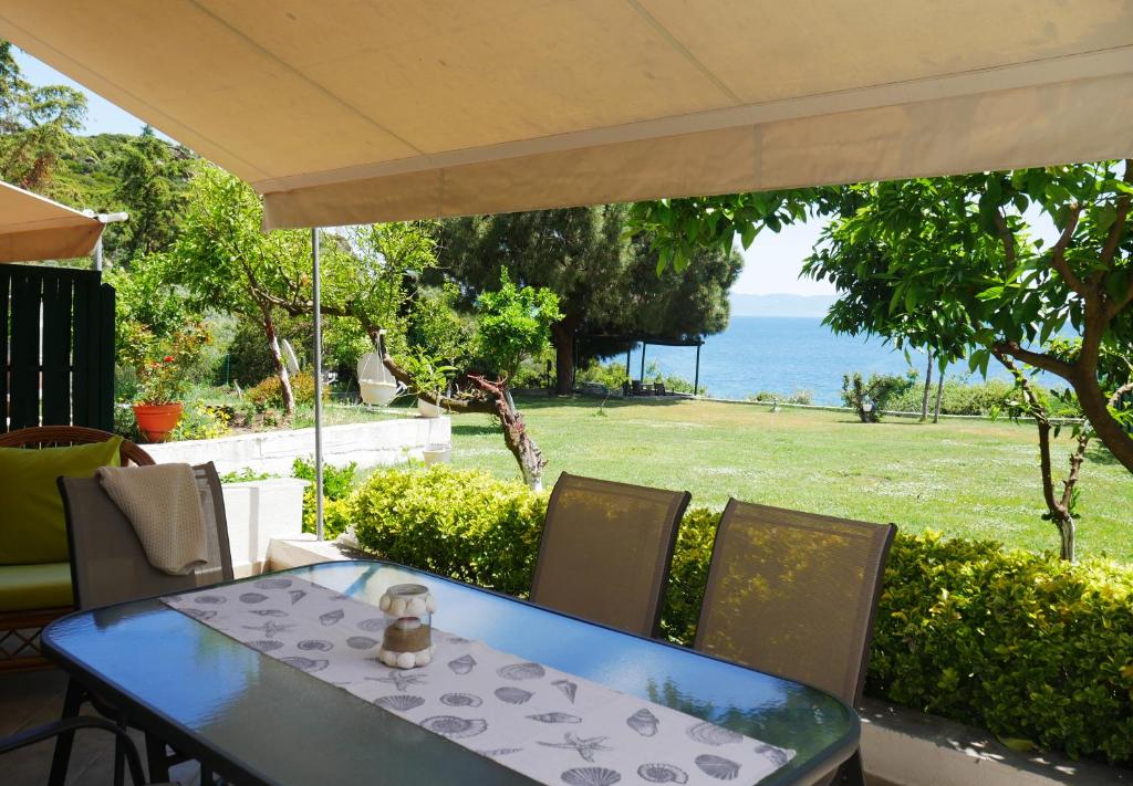 a table and chairs with a view of the ocean at Iraklitsa View in Iraklitsa