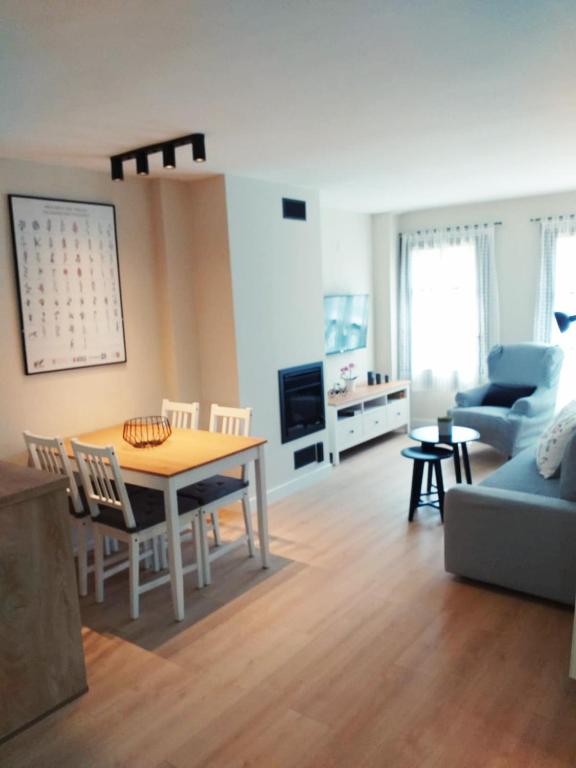 a living room with a table and a couch at Apartamento Casa Bielsa in El Pueyo de Jaca