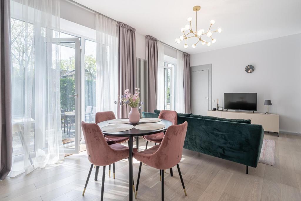 a dining room with a table and chairs at Brand new apartment with terrace near the sea in Jūrmala