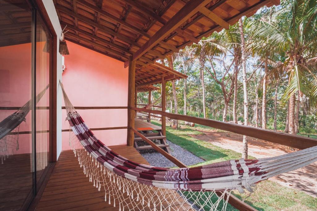 a hammock on the porch of a house at Vila Piê in Itacaré