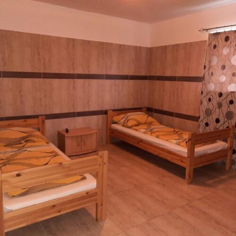 Postel nebo postele na pokoji v ubytování Sanyi Vendégház