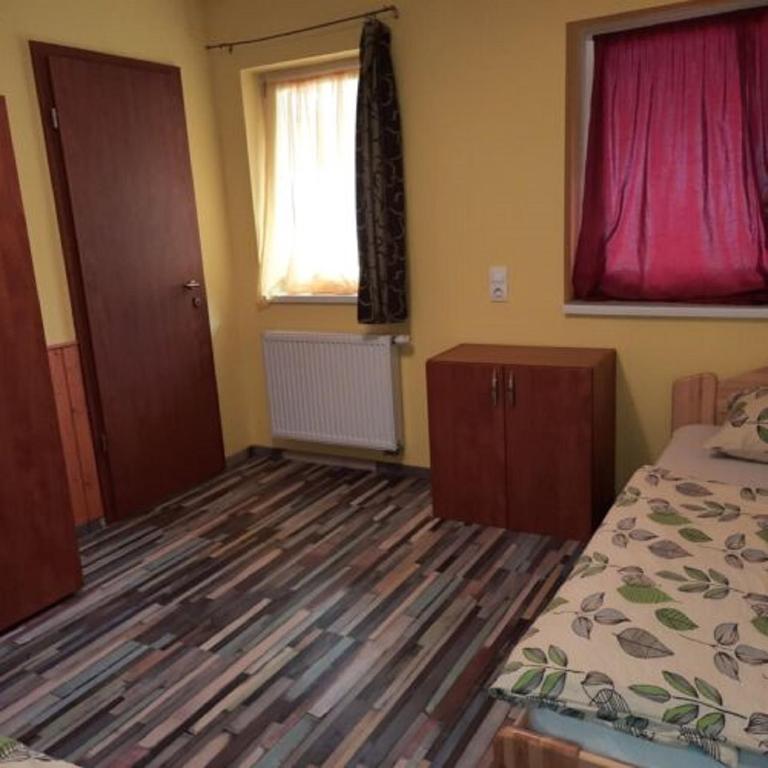 Postel nebo postele na pokoji v ubytování Sanyi Vendégház