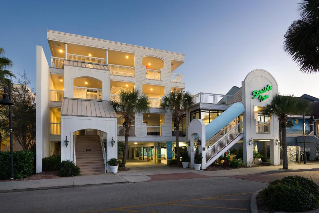 a large building with a slide in front of it at Seaside Inn - Isle of Palms in Isle of Palms