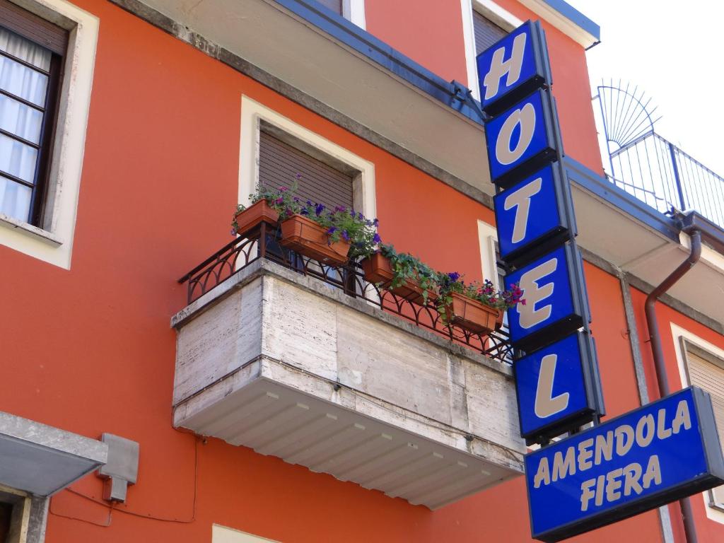 a sign on the side of a building with a balcony at Hotel Amendola Fiera in Milan