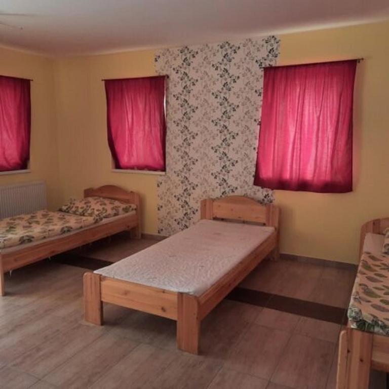 Postel nebo postele na pokoji v ubytování Sanyi Vendégház