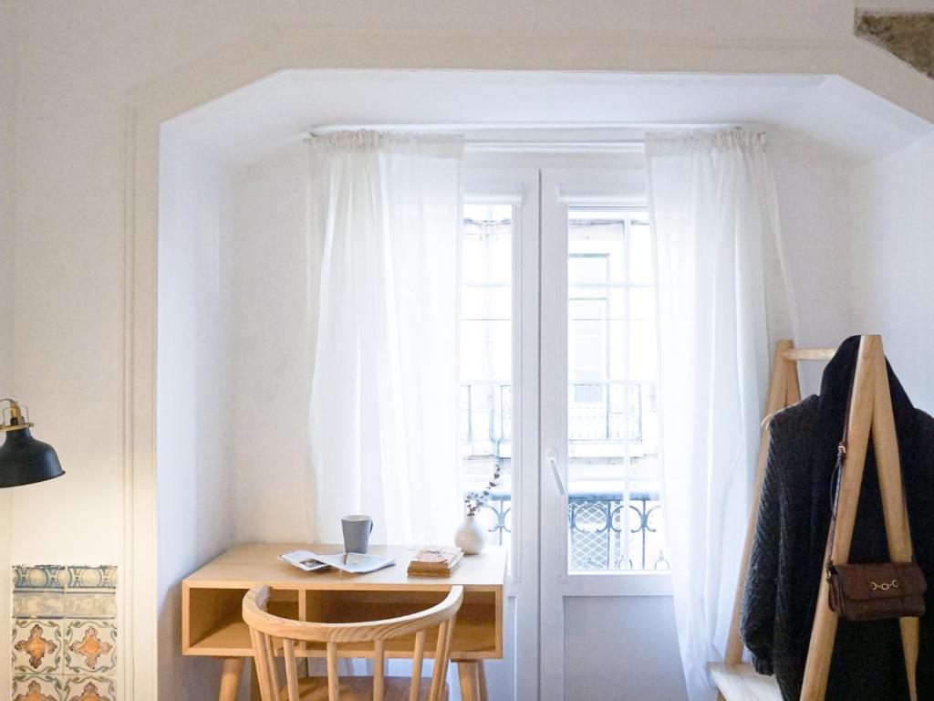 a room with a desk and a window at 262 Baixa Guesthouse in Lisbon