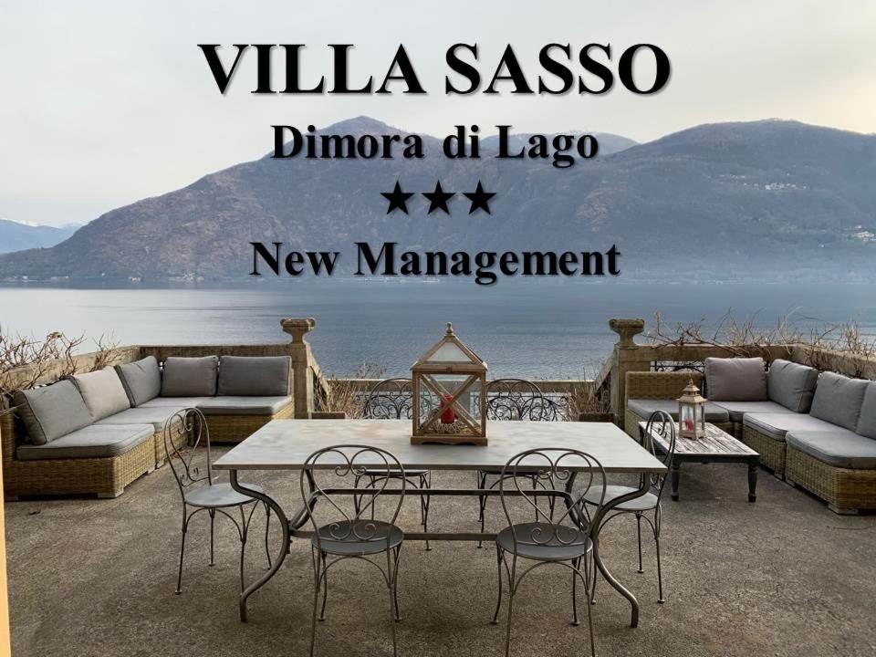 a patio with a table and chairs and the words villa sasso dinoco at VILLA SASSO Dimora di Lago in Cannobio