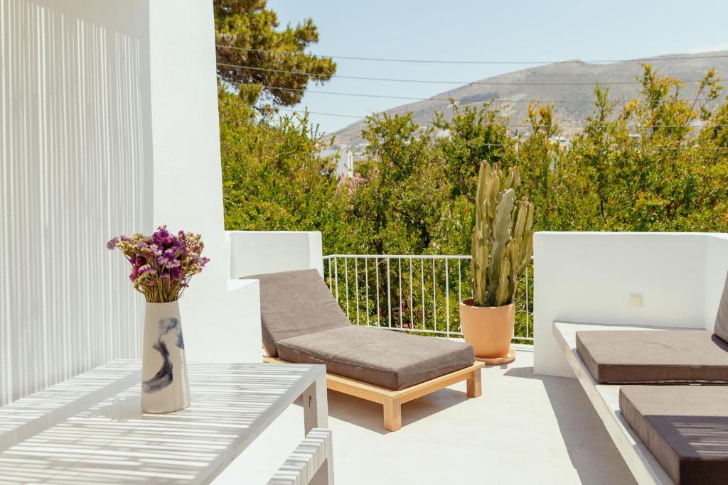 a balcony with a chair and a vase of flowers at Rooftop House in the old town of Parikia - Paros in Parikia