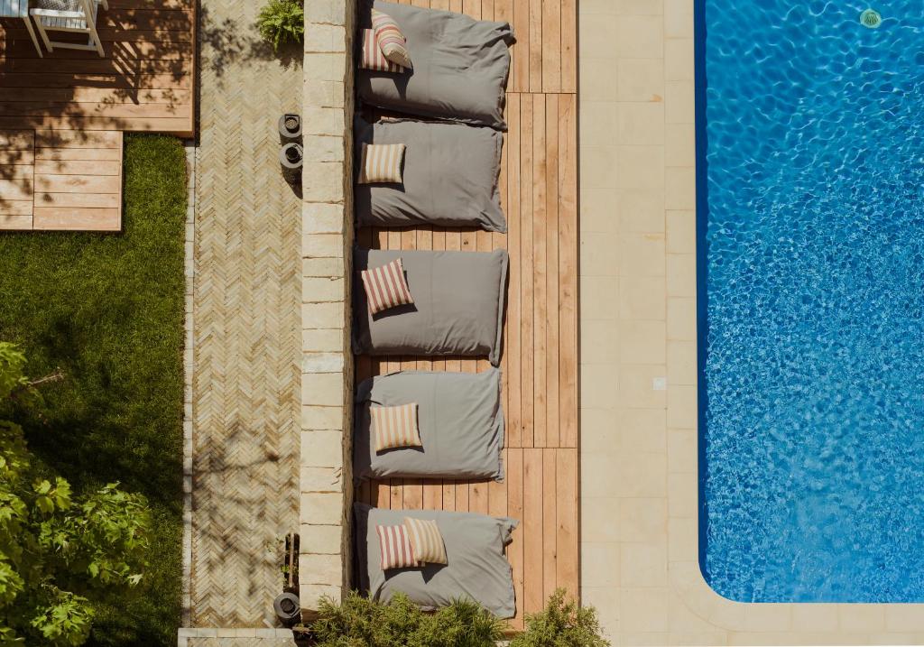 an overhead view of a row of chairs next to a pool at Arome22 in Eforie Sud