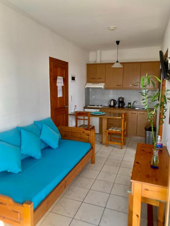 a living room with a bed and a kitchen at Irene Komos in Pitsidia