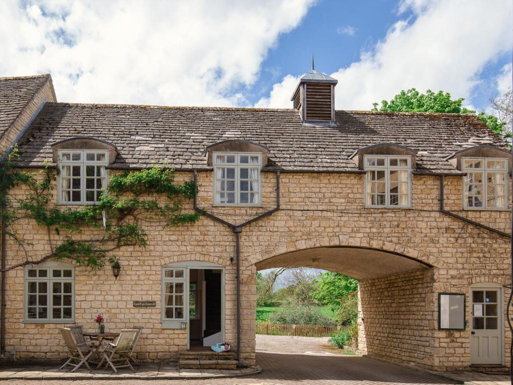 an old brick house with an archway at Lord High Admiral in Winchcombe