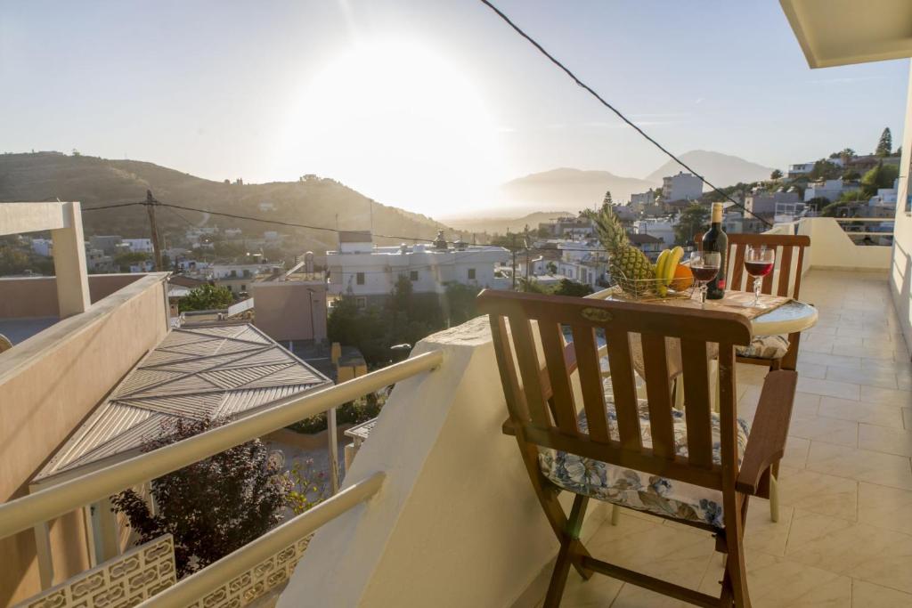 a table and chairs on a balcony with a view at Chryso Apartment in Kamilari