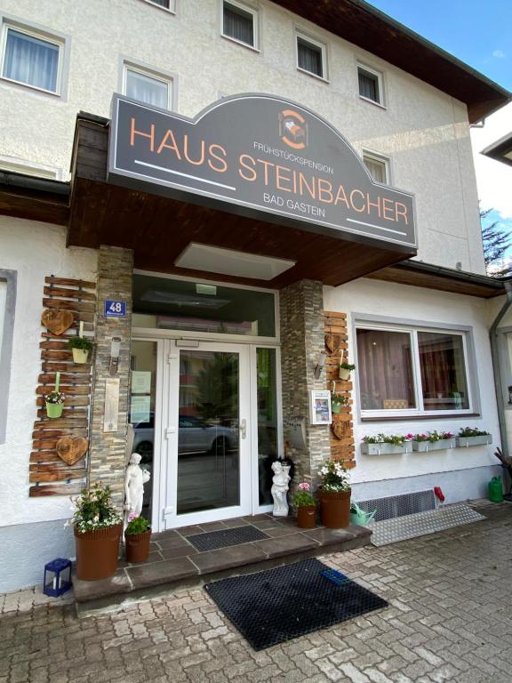 a building with a sign for a haus strinemacist at Pension Steinbacher in Bad Gastein