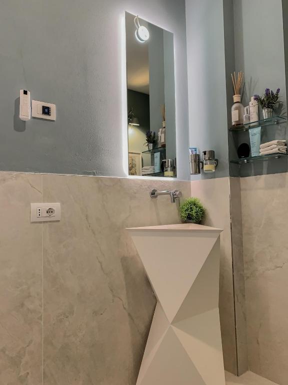 a bathroom with a sink and a mirror at Villa Luminosa in Torre del Lago Puccini
