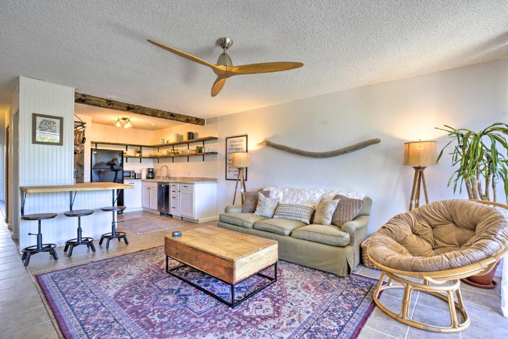 a living room with a couch and a table at Big Island Condo with Pool Access 1 Mi to Beach! in Kailua-Kona