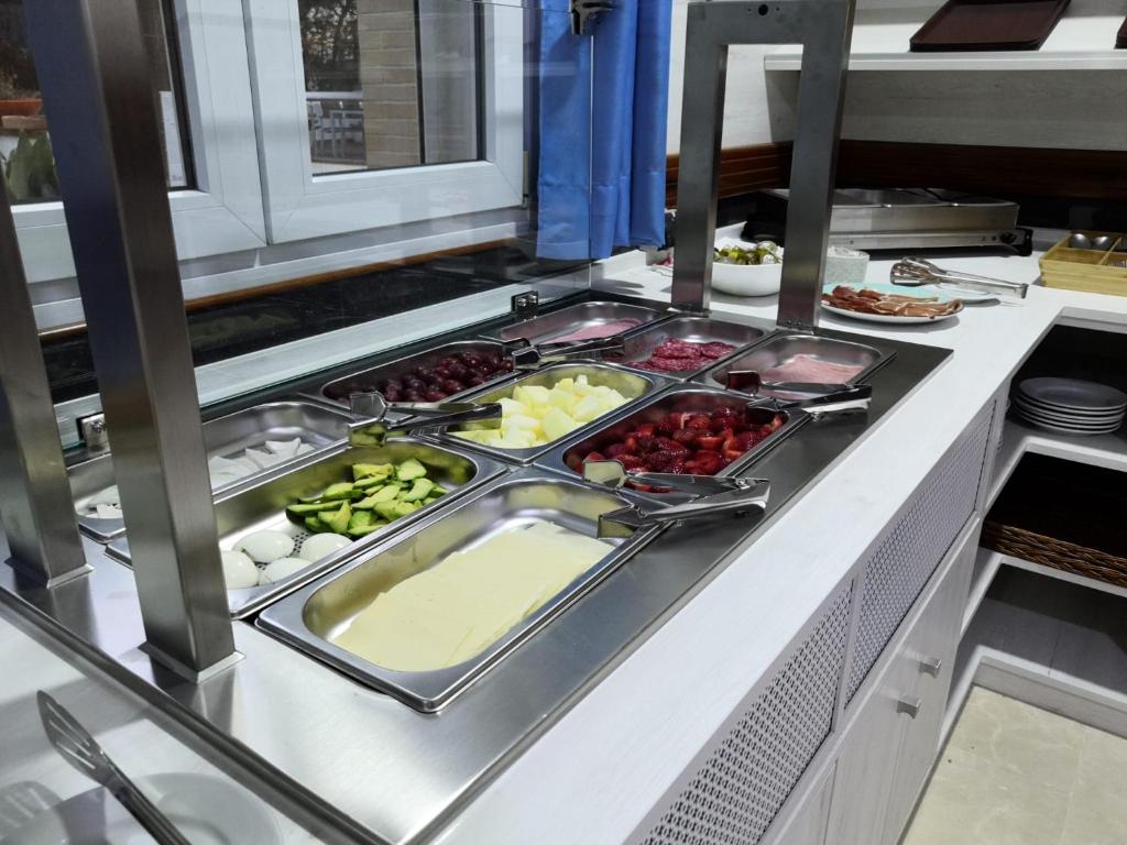 a buffet line with many different types of food at Hotel Marisma Sancti Petri in Chiclana de la Frontera