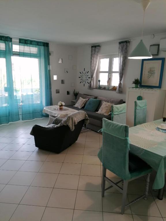 a living room with a couch and a table at Big Blue - Xenija (Veliko Plavetnilo - Ksenija) in Metajna