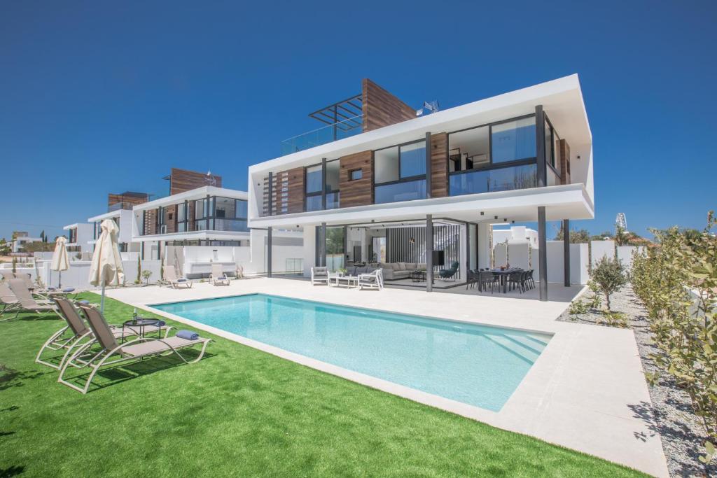 an image of a house with a swimming pool at Elite Pearl Villas in Protaras