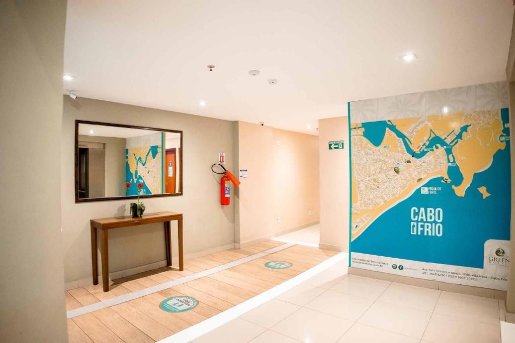 a room with a map on the wall and a table at Green Hotéis in Cabo Frio