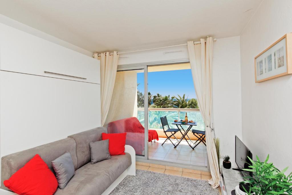 - un salon avec un canapé et une vue sur l'océan dans l'établissement Sea Side YourHostHelper, à Cannes
